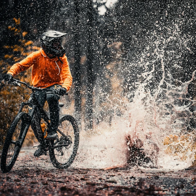 Mountain biker making big splash in puddle