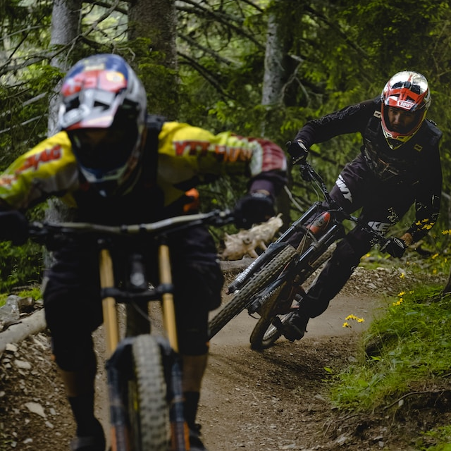Two mountain bikers chasing each other down the trail