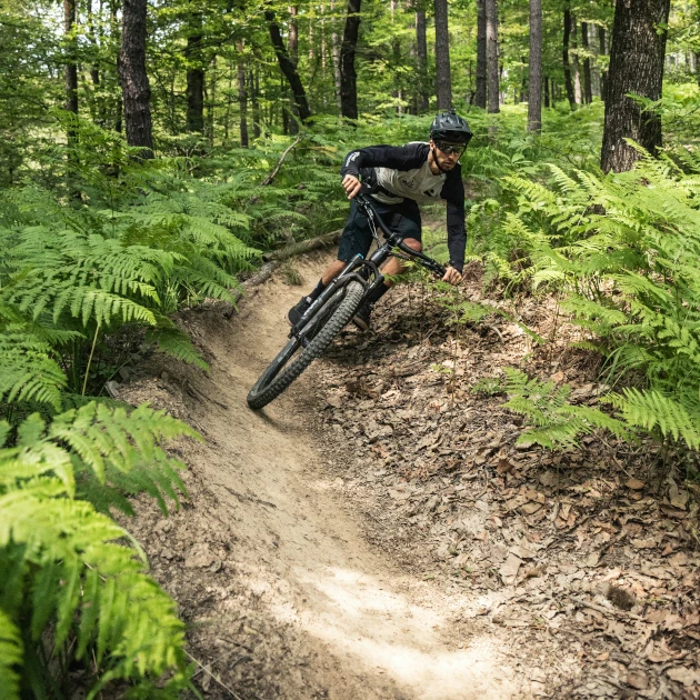 man riding through a dry, dusty, summer berm