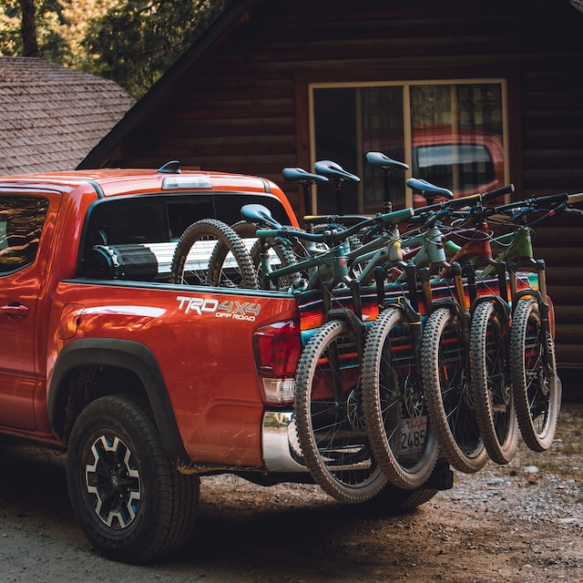Bikes loaded into the back of a pickup truck, ready for riding